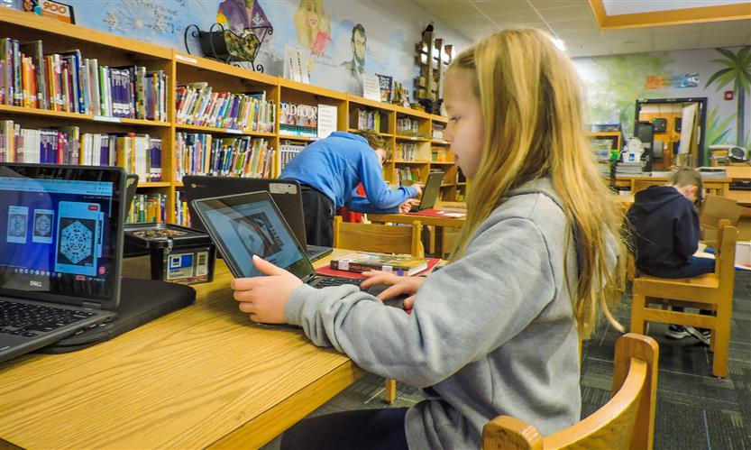 Students on laptops in the library